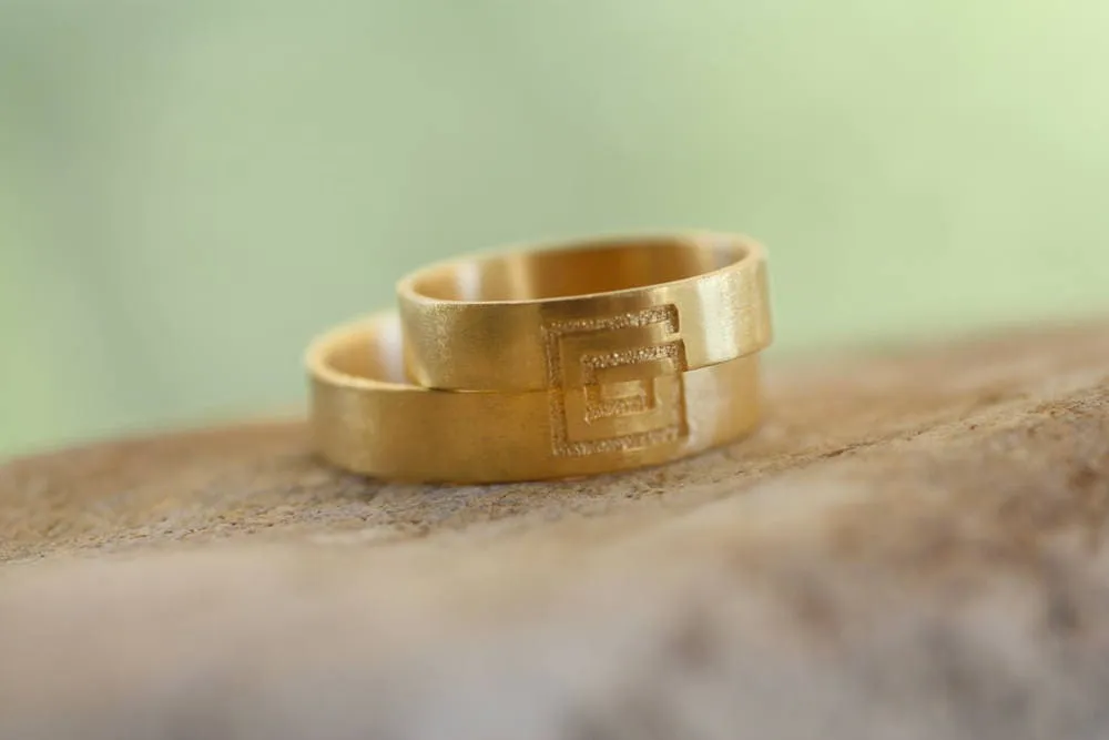 Meander sign Gold wedding bands for couples